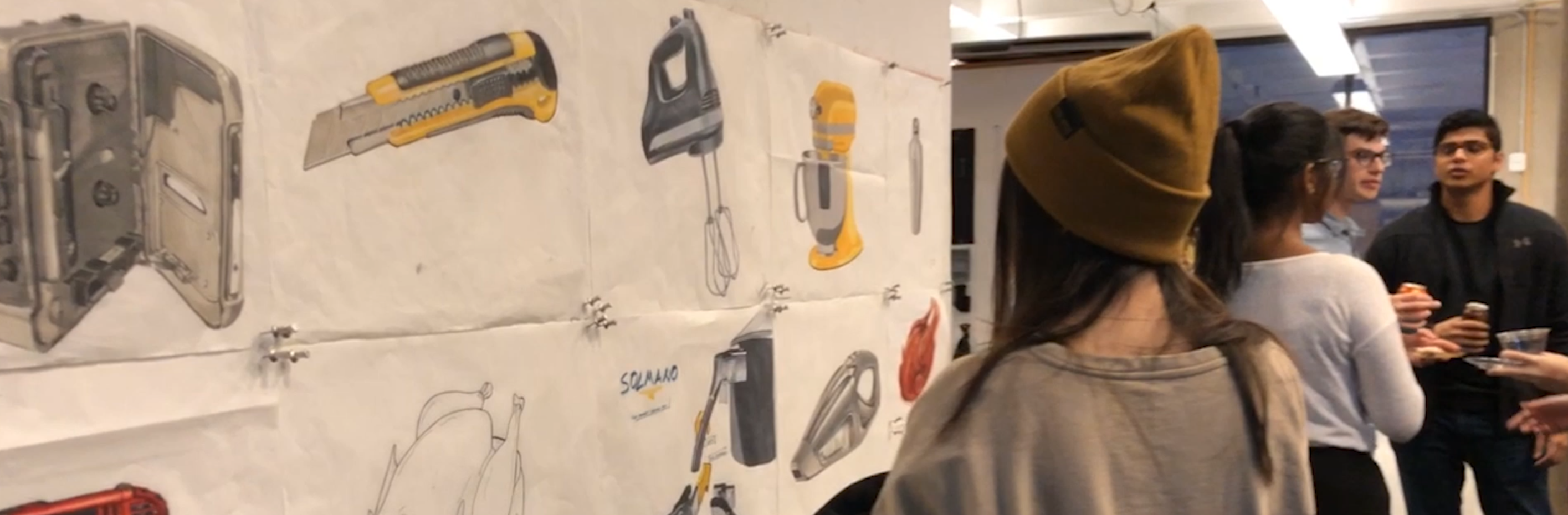 A screenshot of a video showing ID students performing a review of work.